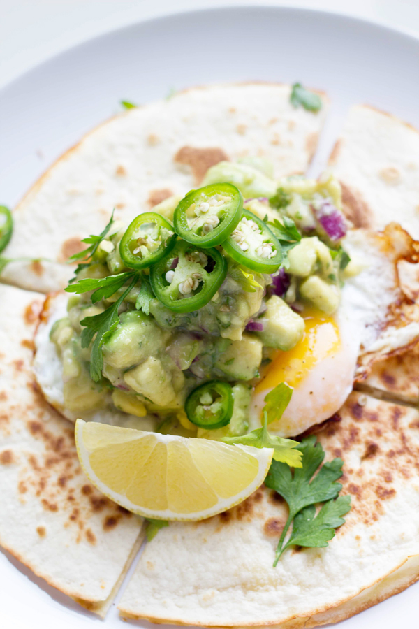 This breakfast quesadilla recipe is filled with melted mozzarella cheese, topped with a fried egg and some spicy guacamole. It definitely packs a breakfast punch! www.seriousspice.com 