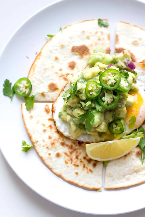 This breakfast quesadilla recipe is filled with melted mozzarella cheese, topped with a fried egg and some spicy guacamole. It definitely packs a breakfast punch! www.seriousspice.com 